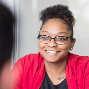 Woman in red sweater smiling at patient