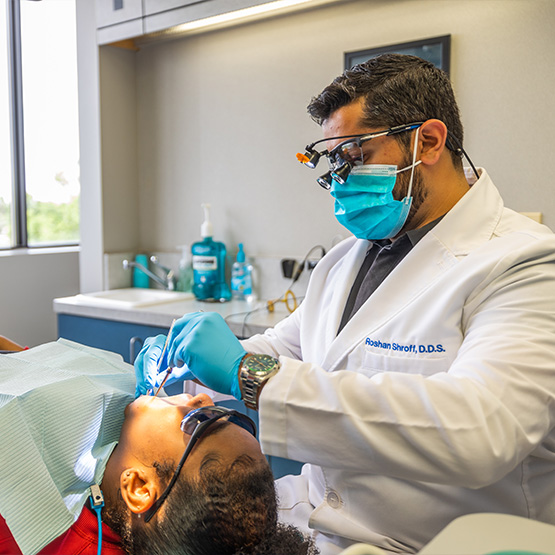 Female dental patient rubbing cheek in pain